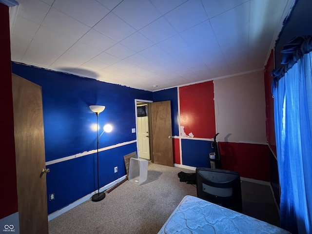 bedroom with baseboards and carpet