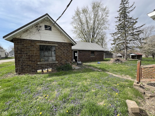 exterior space with brick siding and a front lawn