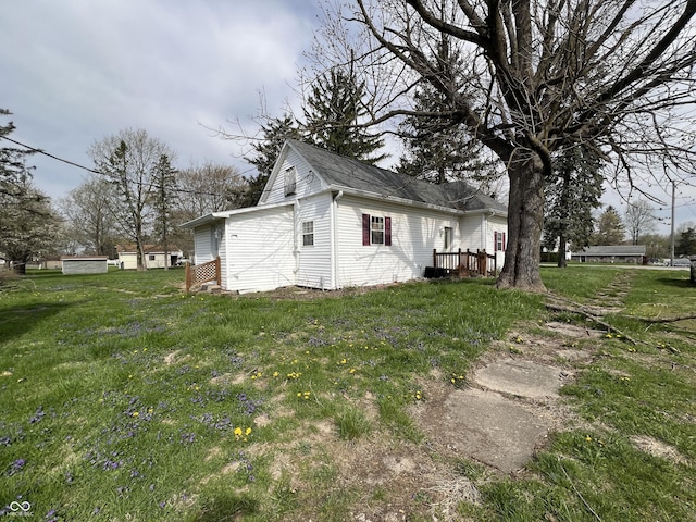view of side of home featuring a yard