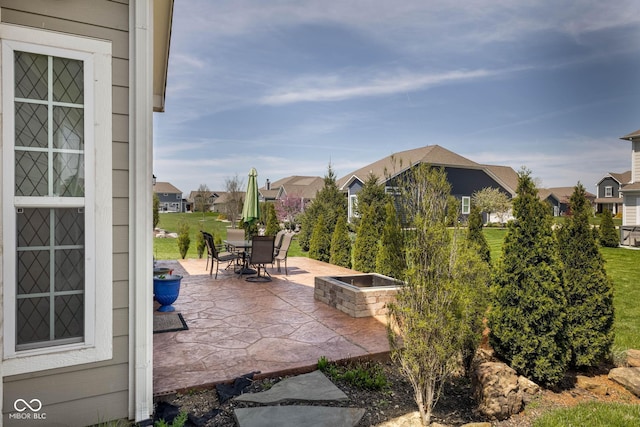 view of patio with a residential view and outdoor dining space
