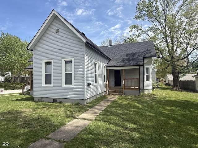 view of front of property featuring covered porch, a shingled roof, a front lawn, and crawl space