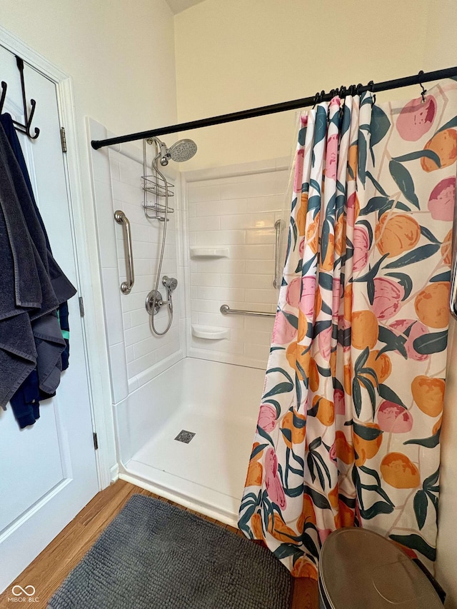 full bath featuring a shower with curtain and wood finished floors
