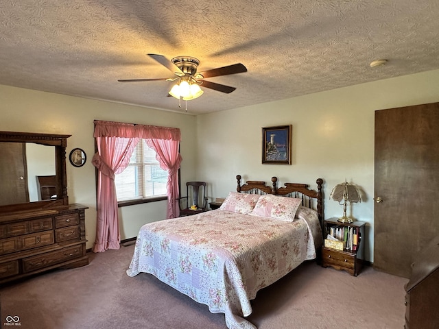carpeted bedroom with a textured ceiling and ceiling fan