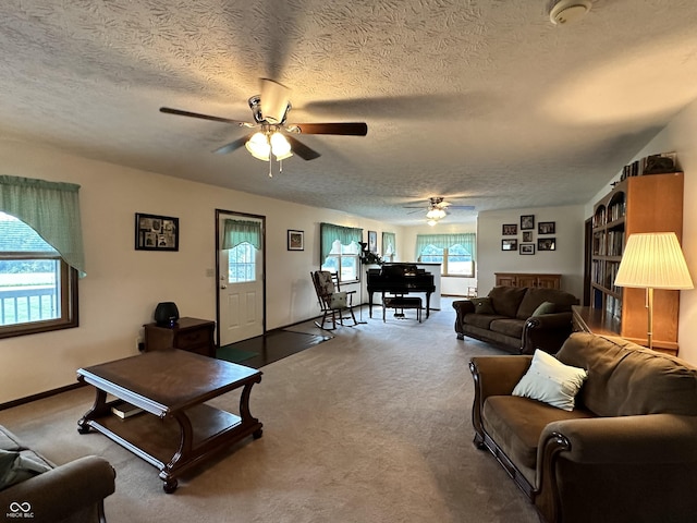 living room with a ceiling fan, carpet flooring, and a textured ceiling