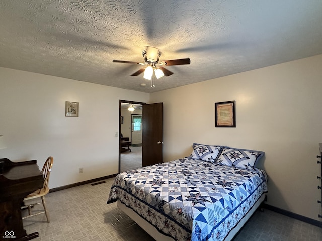 bedroom with visible vents, baseboards, a textured ceiling, carpet flooring, and ceiling fan