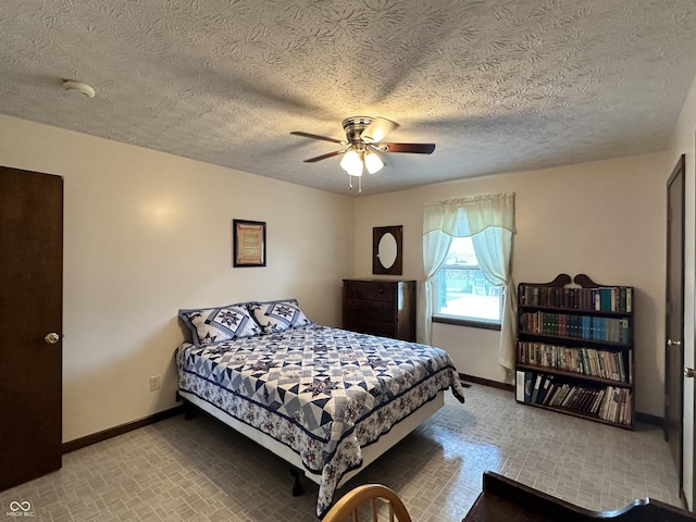 bedroom with carpet floors, baseboards, and a textured ceiling