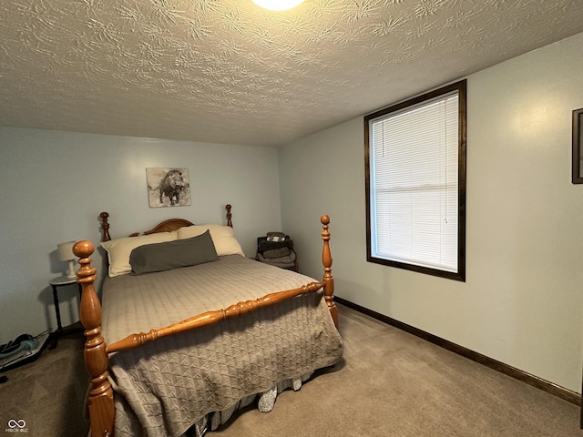 bedroom featuring baseboards, carpet flooring, and a textured ceiling