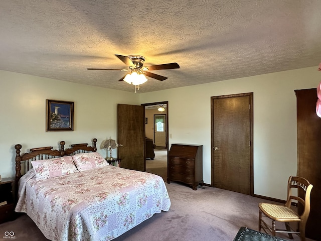 bedroom featuring carpet, a textured ceiling, and ceiling fan