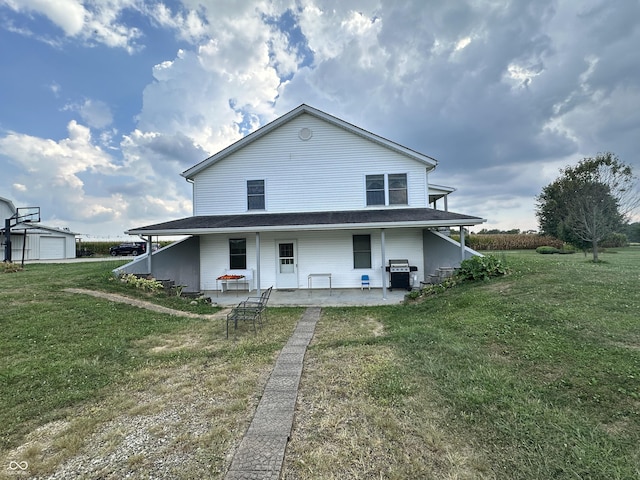 rear view of property with a yard and a patio area