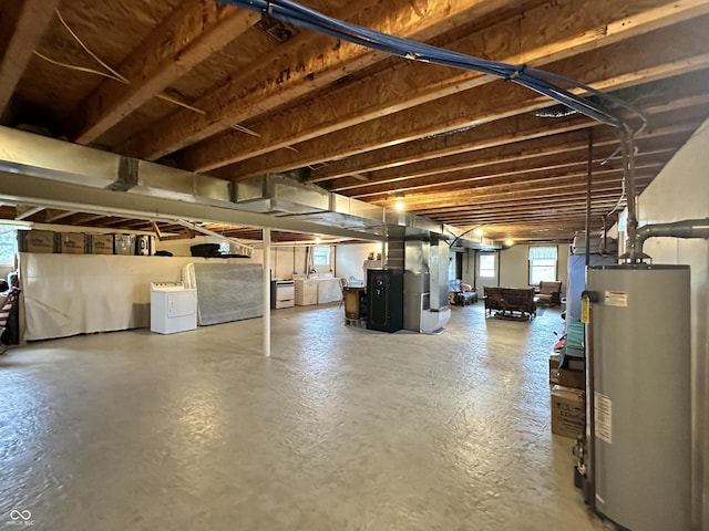below grade area with washing machine and dryer, heating unit, and gas water heater
