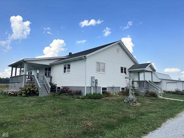 exterior space with a lawn, stairway, a porch, and a chimney