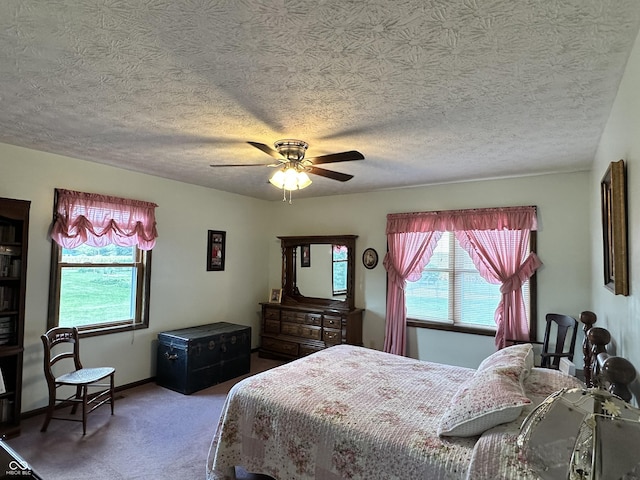 bedroom featuring carpet, a textured ceiling, and ceiling fan