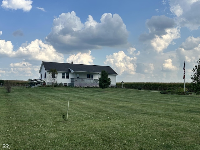 view of front of property with a front lawn and a rural view