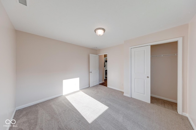 unfurnished bedroom featuring carpet floors, visible vents, and baseboards