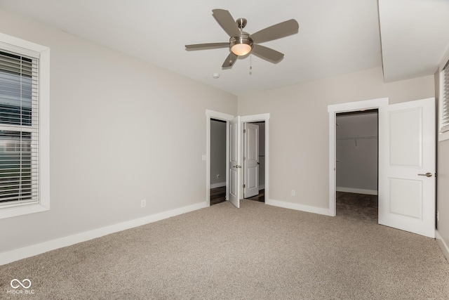 4077 Rookwood Ave, Indianapolis, IN 46208 - unfurnished bedroom featuring a spacious closet, baseboards, a ceiling fan, and carpet floors