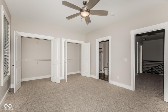 4077 Rookwood Ave, Indianapolis, IN 46208 - unfurnished bedroom featuring baseboards, carpet, two closets, a ceiling fan, and ensuite bath