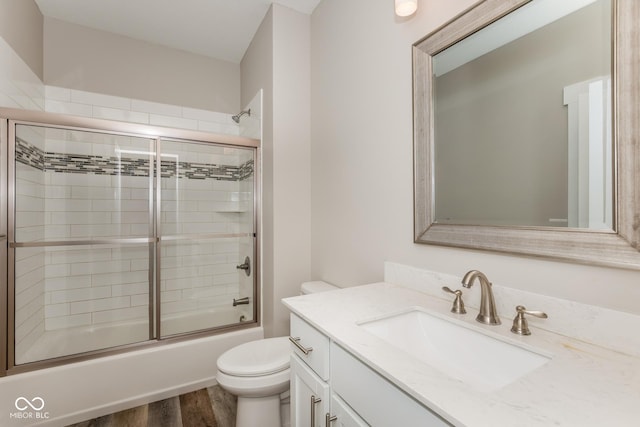 4077 Rookwood Ave, Indianapolis, IN 46208 - bathroom with toilet, vanity, bath / shower combo with glass door, and wood finished floors