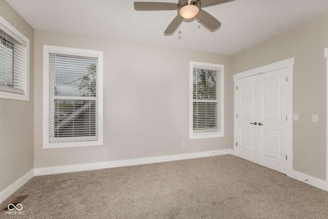 4077 Rookwood Ave, Indianapolis, IN 46208 - unfurnished bedroom featuring baseboards, ceiling fan, a closet, and carpet flooring