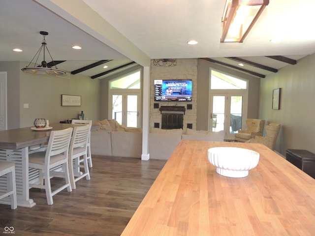 282 W Santee Dr, Greensburg, IN 47240 - dining space featuring a chandelier, healthy amount of natural light, a stone fireplace, dark wood-type flooring, and recessed lighting