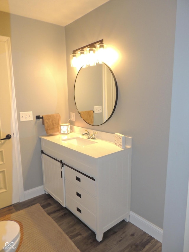 282 W Santee Dr, Greensburg, IN 47240 - bathroom featuring wood finished floors, vanity, and baseboards
