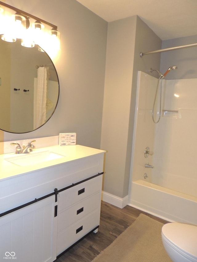 282 W Santee Dr, Greensburg, IN 47240 - full bathroom featuring wood finished floors, baseboards, vanity, toilet, and bathtub / shower combination
