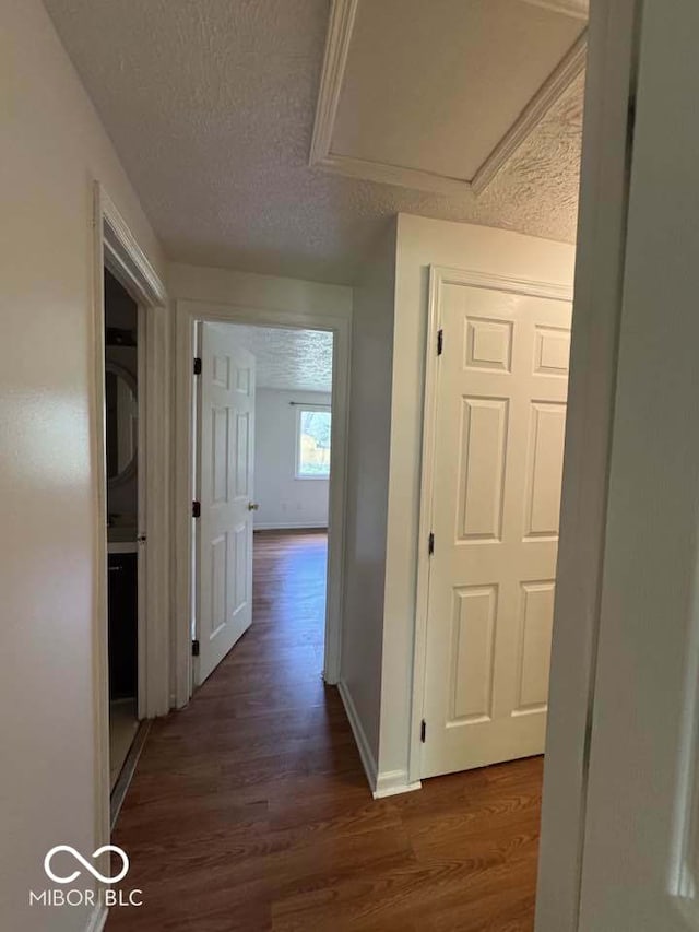 7833 Broadview Dr, Indianapolis, IN 46227 - hall with dark wood-type flooring, a textured ceiling, and baseboards