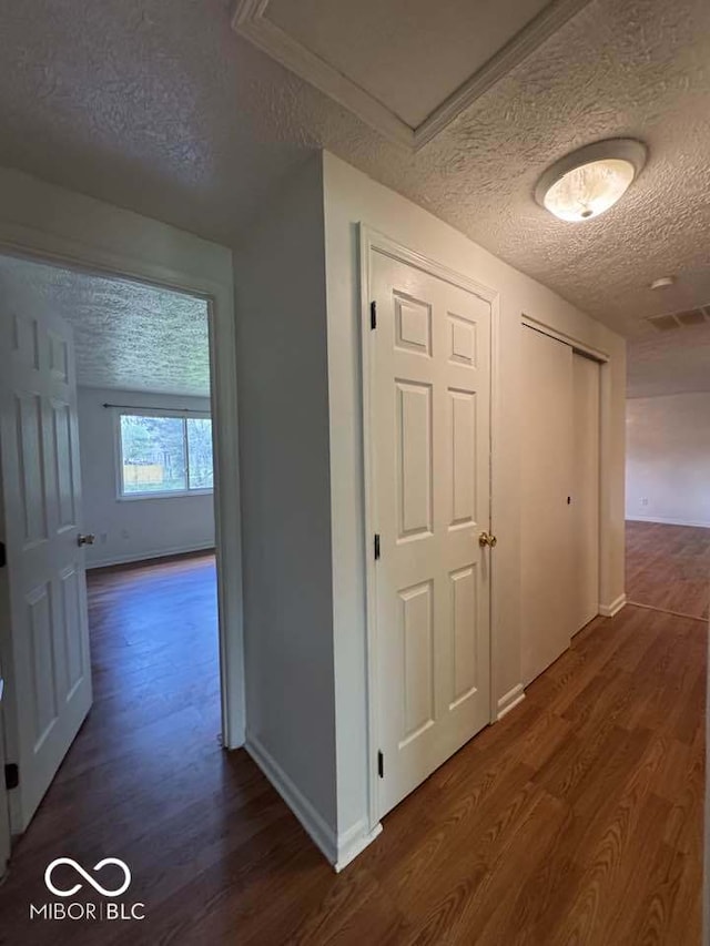 7833 Broadview Dr, Indianapolis, IN 46227 - corridor featuring baseboards, a textured ceiling, dark wood-style floors, and visible vents