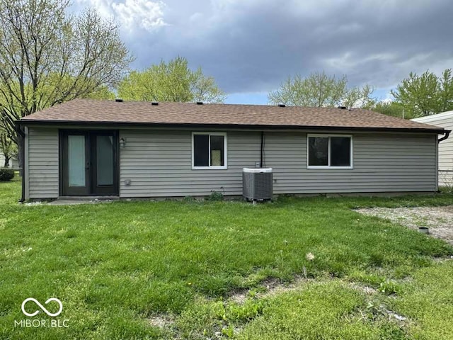 7833 Broadview Dr, Indianapolis, IN 46227 - rear view of property featuring central AC, french doors, a shingled roof, and a lawn