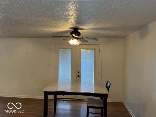 7833 Broadview Dr, Indianapolis, IN 46227 - unfurnished dining area featuring baseboards, a ceiling fan, a textured ceiling, and dark wood-style floors