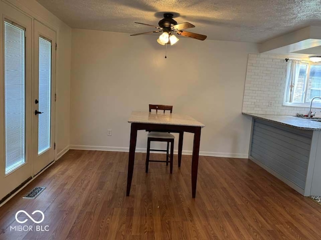 7833 Broadview Dr, Indianapolis, IN 46227 - unfurnished dining area with wood finished floors, visible vents, a ceiling fan, a sink, and a textured ceiling