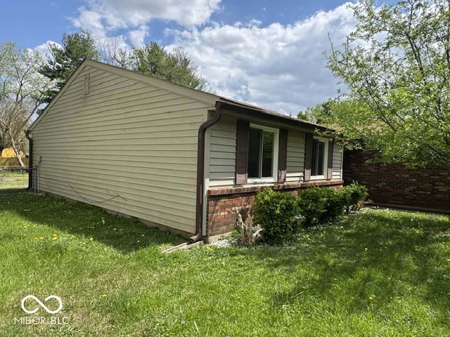 7833 Broadview Dr, Indianapolis, IN 46227 - view of property exterior with a lawn, fence, and brick siding
