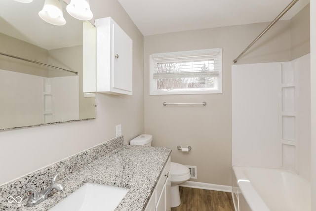 9535 E Michigan St, Indianapolis, IN 46229 - full bath featuring vanity, toilet, bathtub / shower combination, baseboards, and wood finished floors