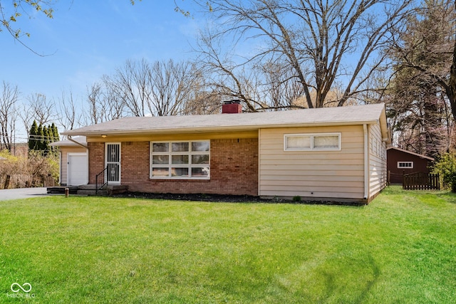 9535 E Michigan St, Indianapolis, IN 46229 - ranch-style house with a chimney, brick siding, a front yard, and an attached garage