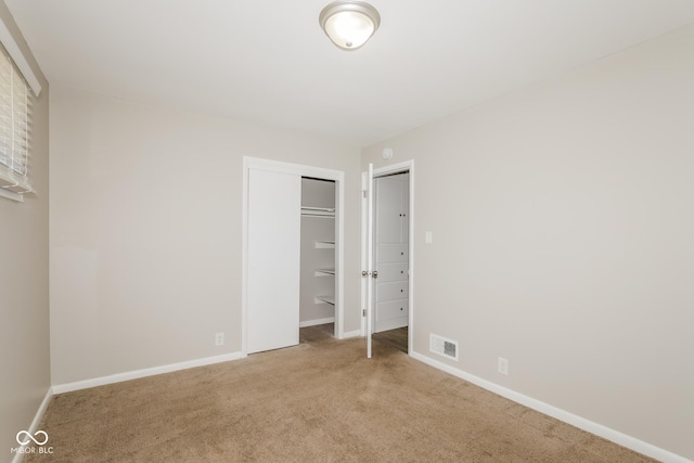 9535 E Michigan St, Indianapolis, IN 46229 - unfurnished bedroom featuring baseboards, visible vents, and carpet flooring