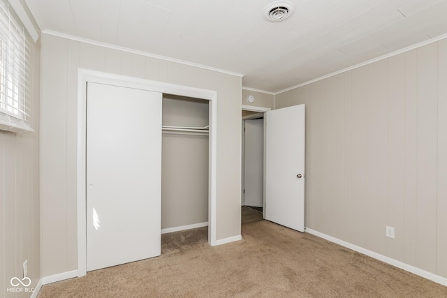 9535 E Michigan St, Indianapolis, IN 46229 - unfurnished bedroom featuring crown molding, a closet, visible vents, and carpet