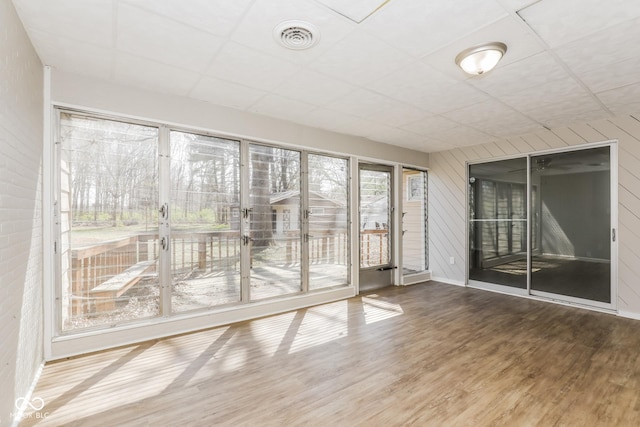 9535 E Michigan St, Indianapolis, IN 46229 - interior space featuring wood walls, visible vents, baseboards, wood finished floors, and a paneled ceiling