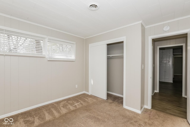 9535 E Michigan St, Indianapolis, IN 46229 - unfurnished bedroom with a closet, ornamental molding, light carpet, baseboards, and visible vents