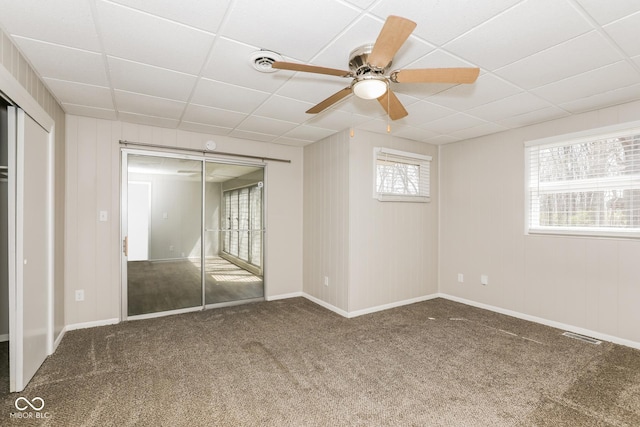 9535 E Michigan St, Indianapolis, IN 46229 - unfurnished bedroom with a closet, carpet, ceiling fan, visible vents, and a paneled ceiling