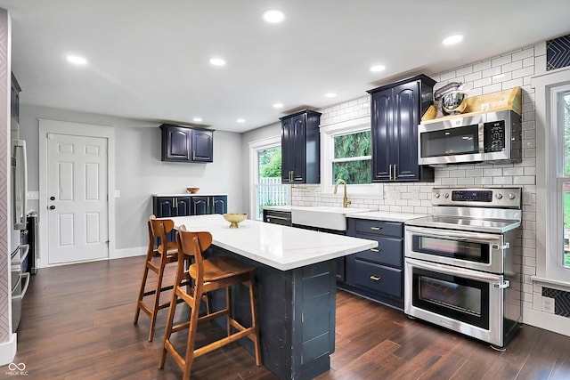 11626 Forest Dr, Carmel, IN 46033 - kitchen with stainless steel appliances, a sink, backsplash, dark wood-style flooring, and recessed lighting