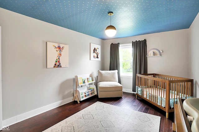 11626 Forest Dr, Carmel, IN 46033 - bedroom featuring baseboards, a nursery area, and wood finished floors