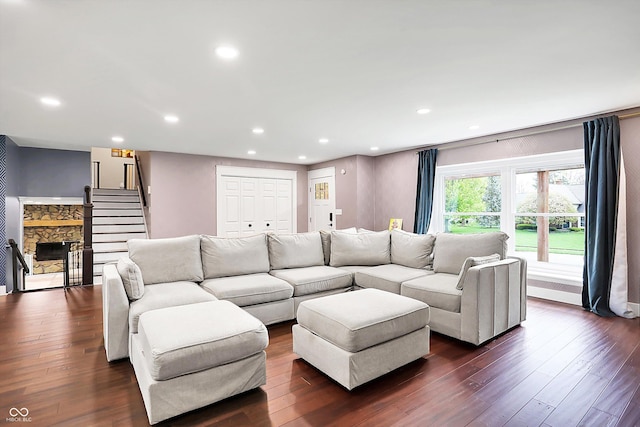 11626 Forest Dr, Carmel, IN 46033 - living area with a stone fireplace, recessed lighting, dark wood-type flooring, and stairway