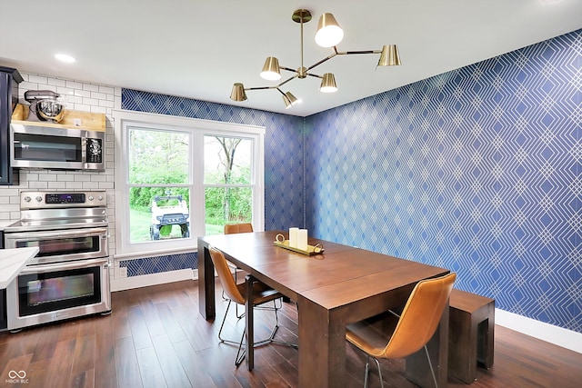 11626 Forest Dr, Carmel, IN 46033 - dining area with a chandelier, dark wood-style floors, and wallpapered walls