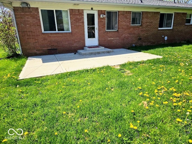 8230 E 11th St, Indianapolis, IN 46219 - exterior space featuring a shingled roof, brick siding, a yard, and a patio