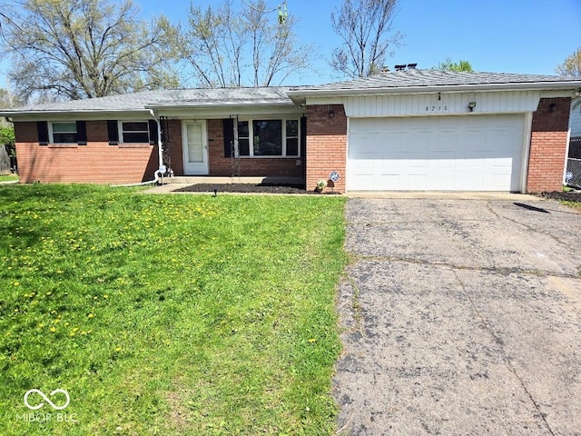 8230 E 11th St, Indianapolis, IN 46219 - ranch-style house with an attached garage, brick siding, driveway, and a front lawn