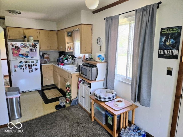 8230 E 11th St, Indianapolis, IN 46219 - kitchen featuring stainless steel microwave, a sink, light countertops, and freestanding refrigerator