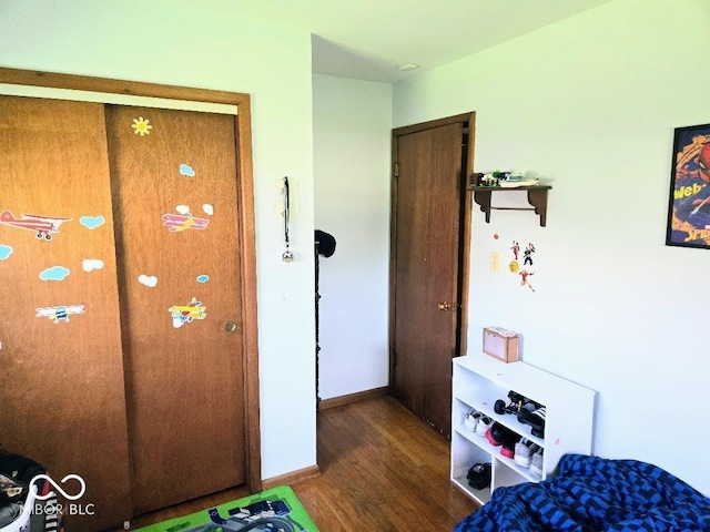 8230 E 11th St, Indianapolis, IN 46219 - bedroom featuring baseboards and wood finished floors