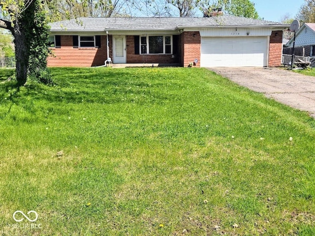8230 E 11th St, Indianapolis, IN 46219 - single story home with brick siding, a front yard, a garage, and aphalt driveway