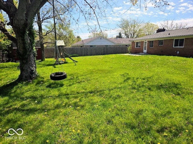 8230 E 11th St, Indianapolis, IN 46219 - view of yard with a patio area, a fenced backyard, and a playground