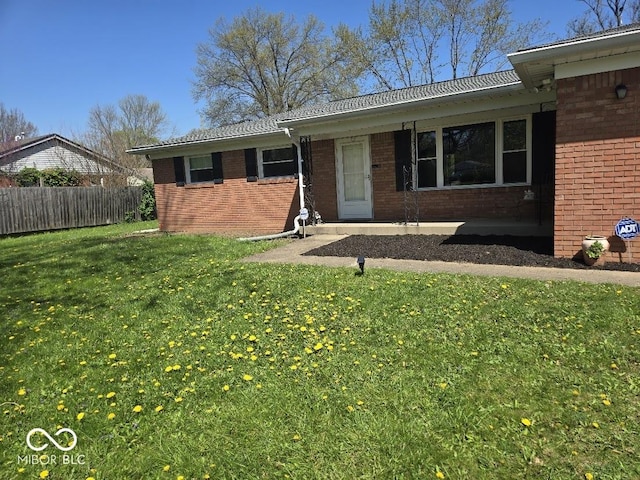 8230 E 11th St, Indianapolis, IN 46219 - single story home with brick siding, fence, and a front yard