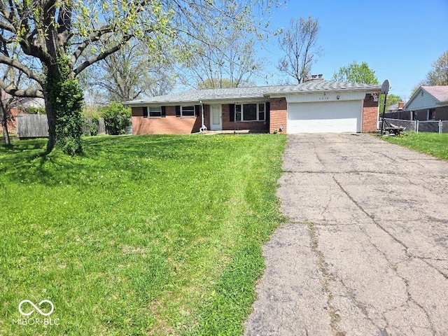 8230 E 11th St, Indianapolis, IN 46219 - ranch-style house with a front lawn, aphalt driveway, fence, a garage, and brick siding